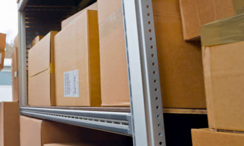 Stacked boxes on metal racks.