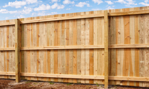 A large wooden fence enclosing a yard.