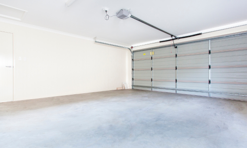 An empty garage with the overhead door closed.